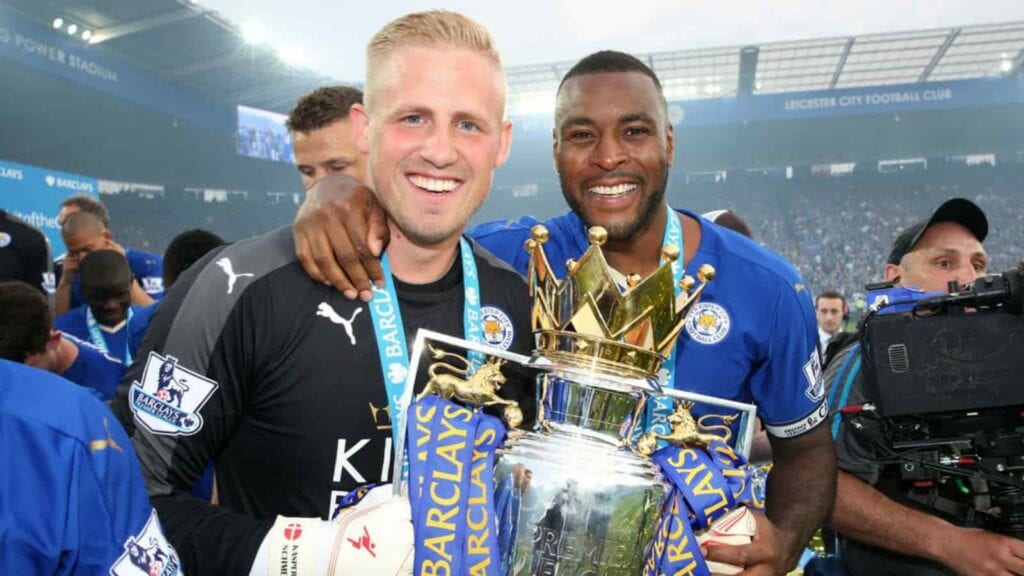 Wes Morgan and Kasper Schmeichel with the Premier League trophy in 2016