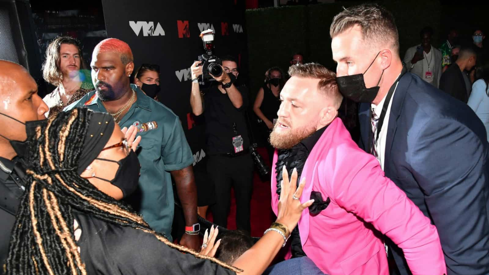 Conor McGregor throws a drink at Machine Gun Kelly following an ugly altercation at MTV Video Music Awards