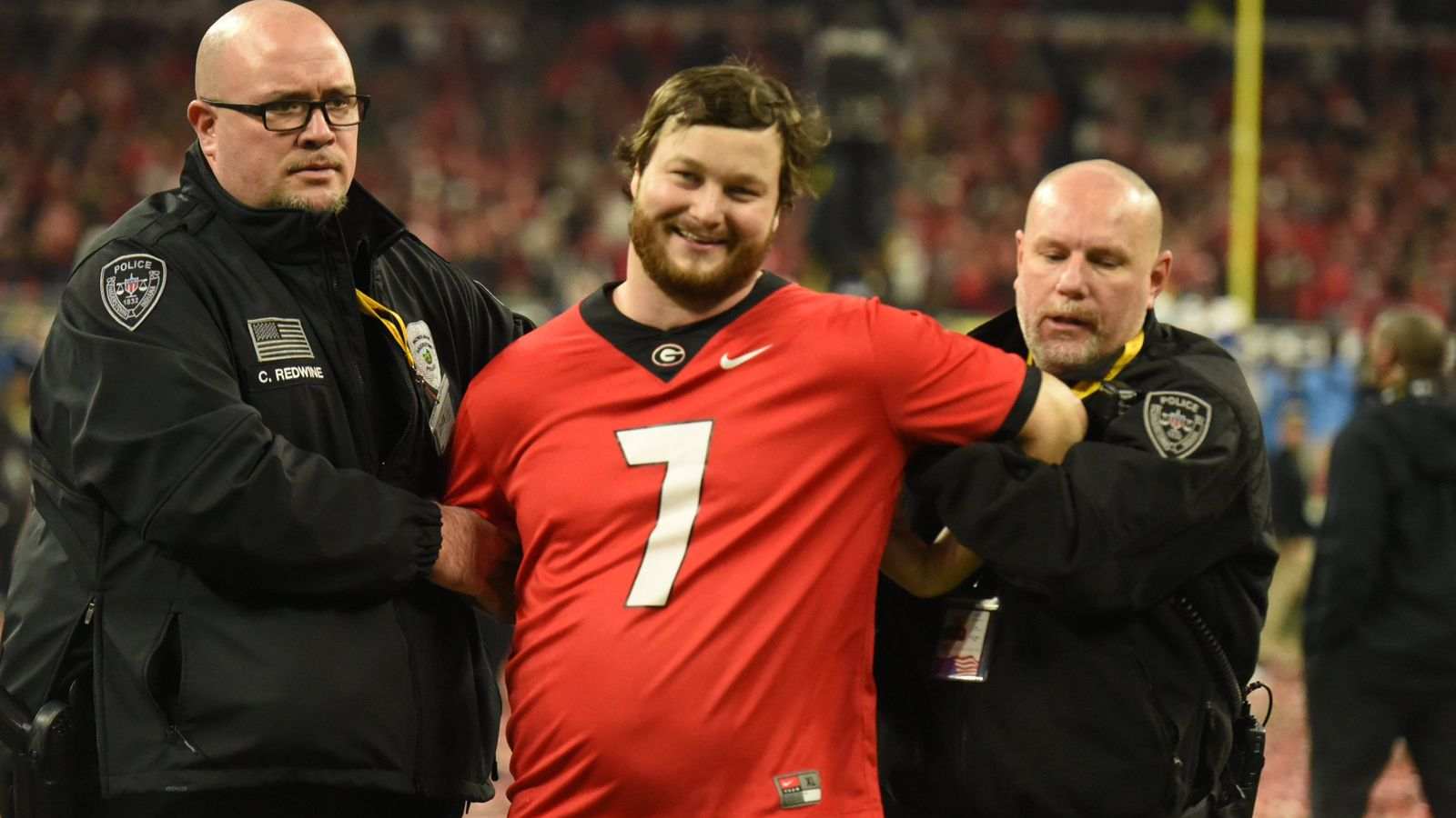 Watch: Georgia Bulldogs fan gets cheered after getting arrested for rushing the field