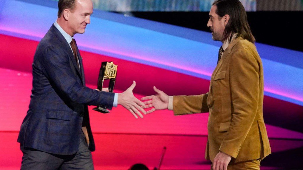 Aaron Rodgers receiving his MVP from Peyton Manning