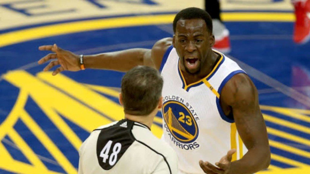 Draymond Green having a heated exchange with a ref.