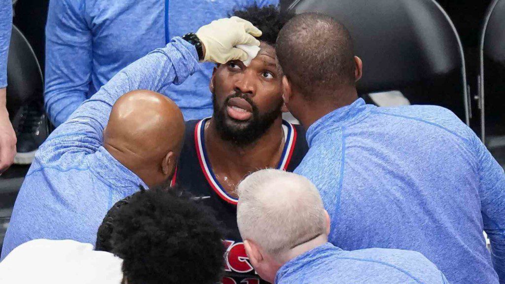 Joel Embiid examined on court