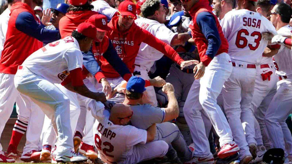 Mets' Pete Alonso is taken to the ground by St. Louis Cardinals first base coach Stubby Clapp