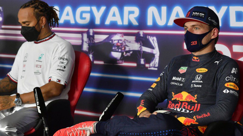 Max Verstappen alongside Lewis Hamilton during a press conference