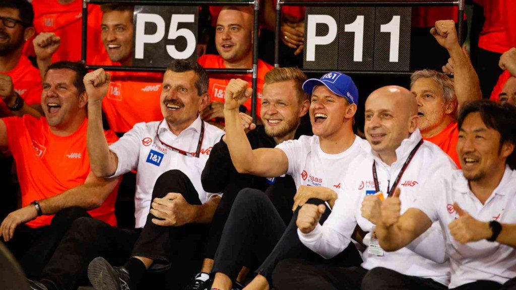 Kevin Magnussen and Mick Schumacher with the team after the 2022 Bahrain GP