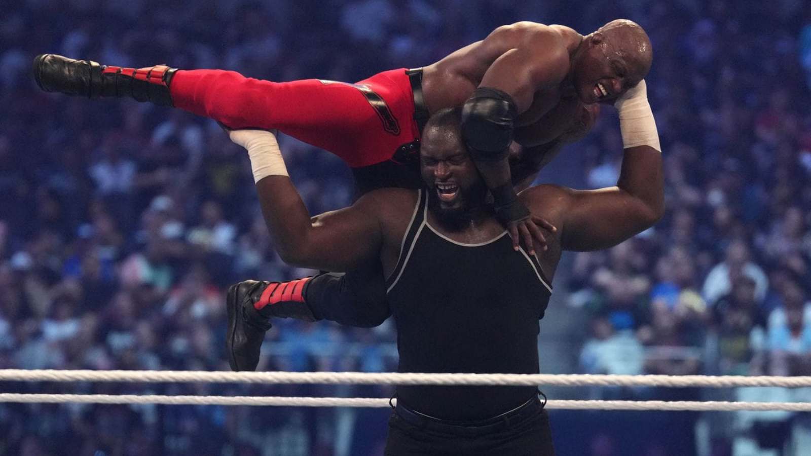 WATCH: Omos throws Bobby Lashley through the steel cage on Monday Night Raw