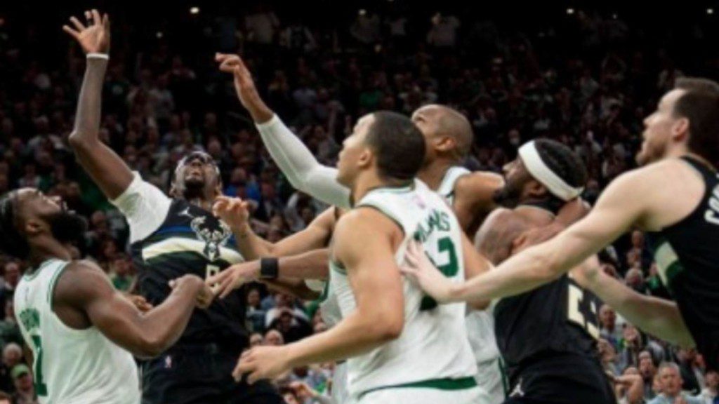 Milwaukee Bucks and Boston Celtics' players contesting to get a rebound