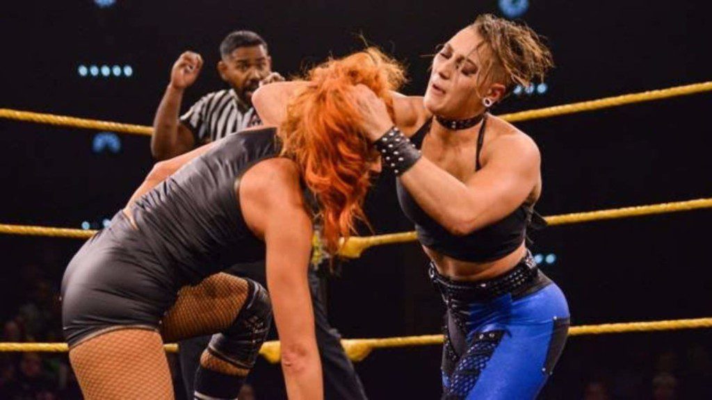 Rhea Ripley tries to make Becky Lynch fall over the ropes in a funny way