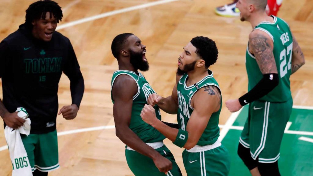 Jayson Tatum, Jaylen Brown and Celtics plaers celebrate the win