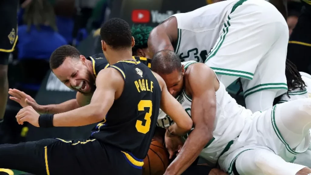 Stephen Curry getting injured during a loose ball play by Al Horford with several players in action