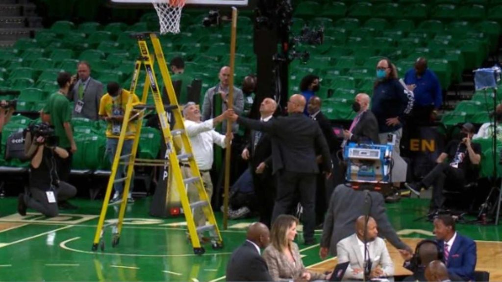 The Celtics management team fixing the rim's height