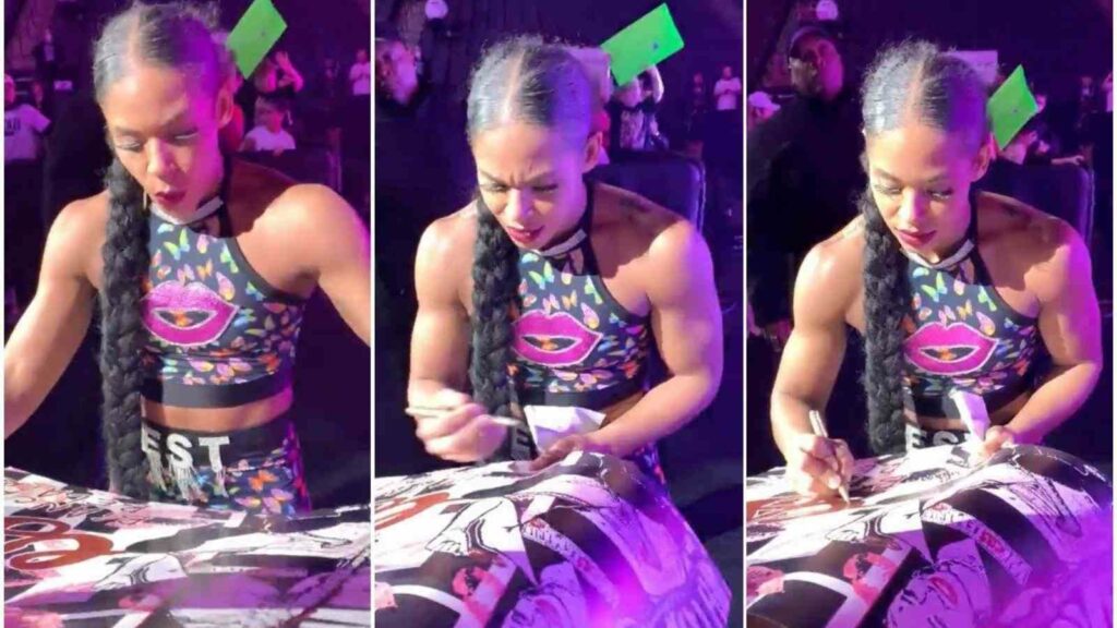 Bianca Belair while signing 