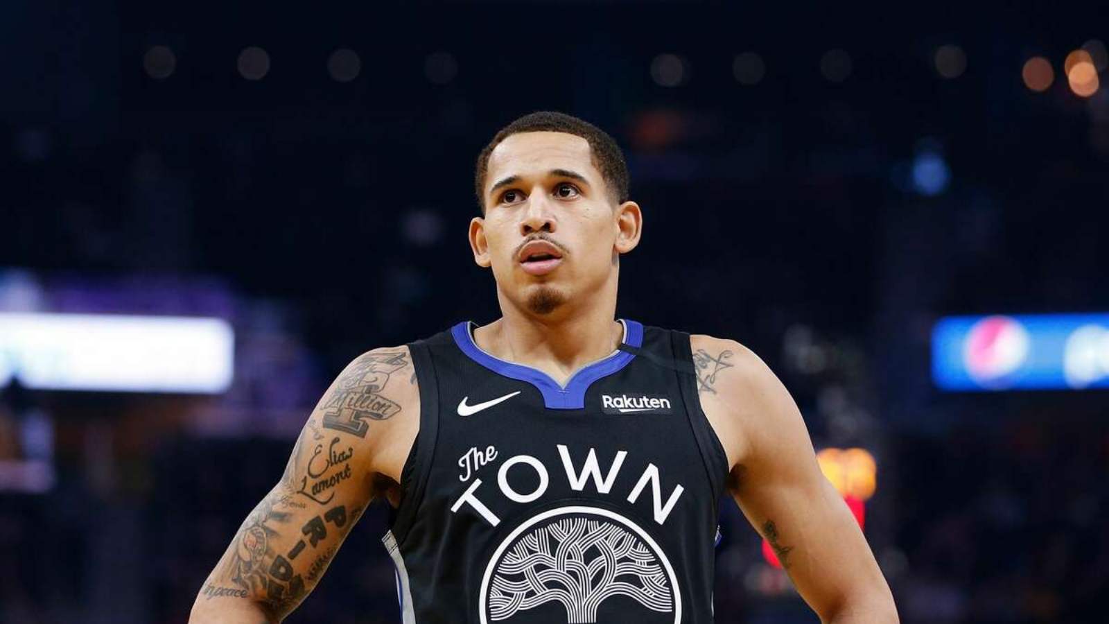 Juan Toscano Anderson in Los Angeles Lakers gear spotted courtside cheering against the Warriors