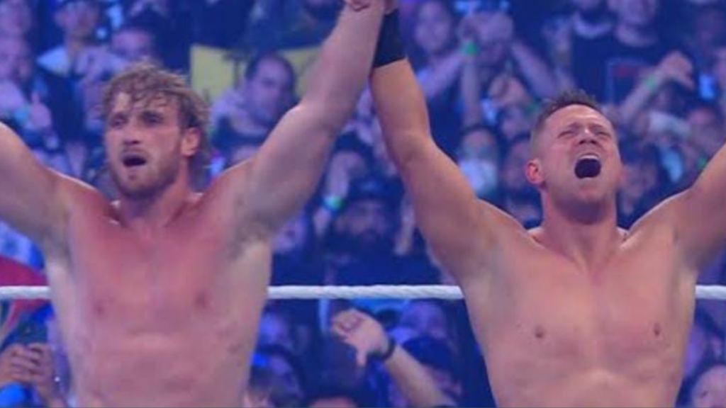 Logan Paul with the Miz after winning against the Mysterios at WrestleMania 38