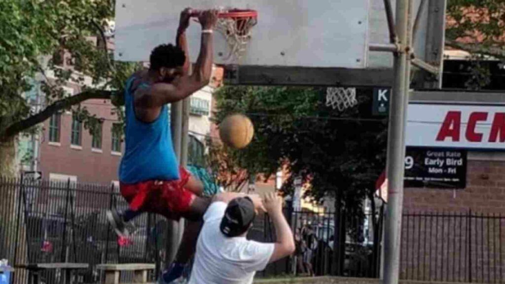 Joel Embiid dunking on a random guy