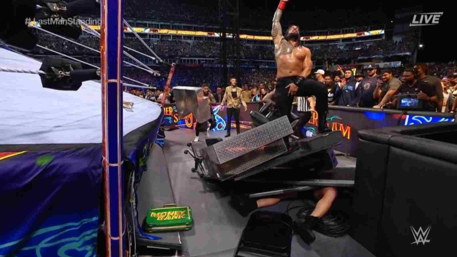 WATCH : Roman Reigns and The Usos brutally bury Brock Lesnar under the pile of Announcers desk and steel steps