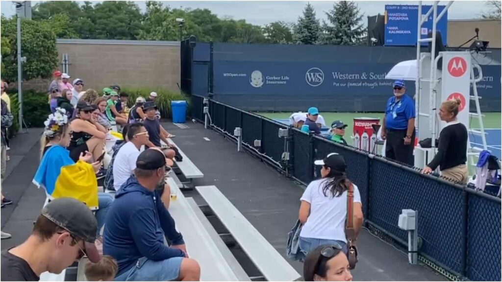 Official at Cincinnati Open in discussion with Lola, the fan escorted out of the stands