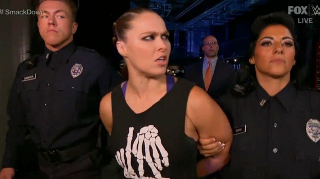 WATCH : Ronda Rousey savagely BEATS up security guards to kick-off Smackdown, gets arrested after refusing to leave the arena