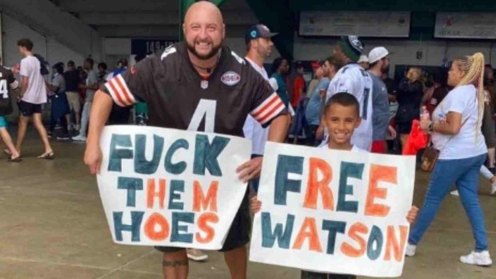 “Pathetic” – Internet blast a father-son duo for their ‘f**k them hoes, FREE Deshaun Watson’ posters at preseason game