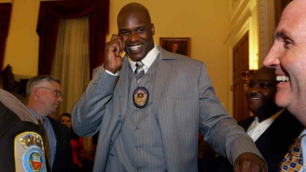 Shaquille O'Neal showing his badge