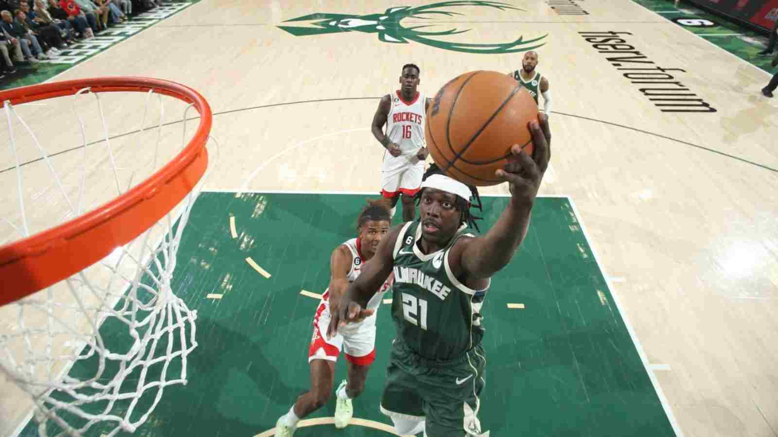 Jrue Holiday goes past Jalen Green for the basket