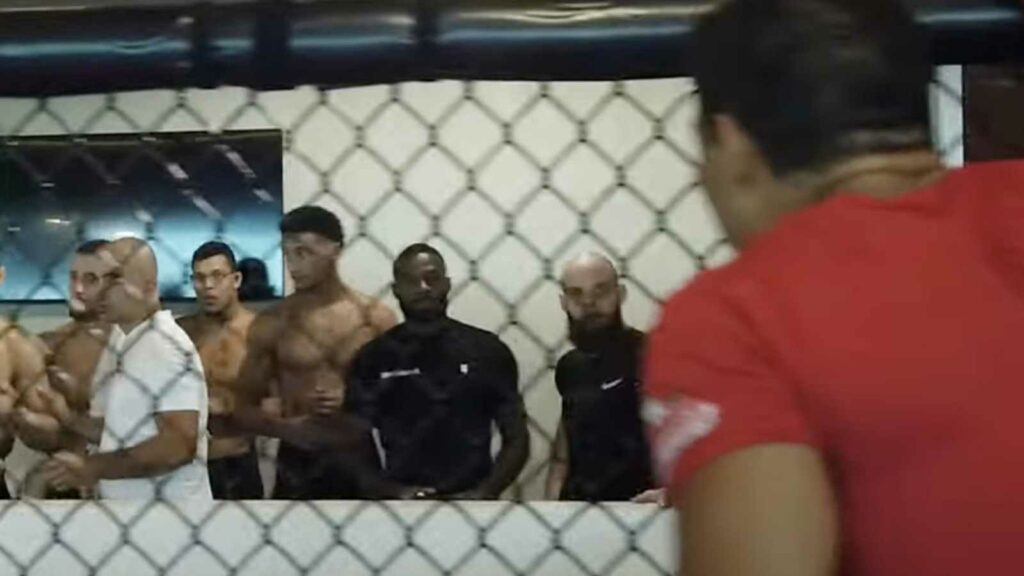 Paulo Costa (in red) squares up against Khamzat Chimaev and his team (Background)