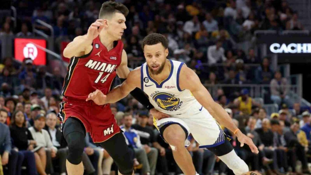 Stephen Curry guarded by Tyler Herro