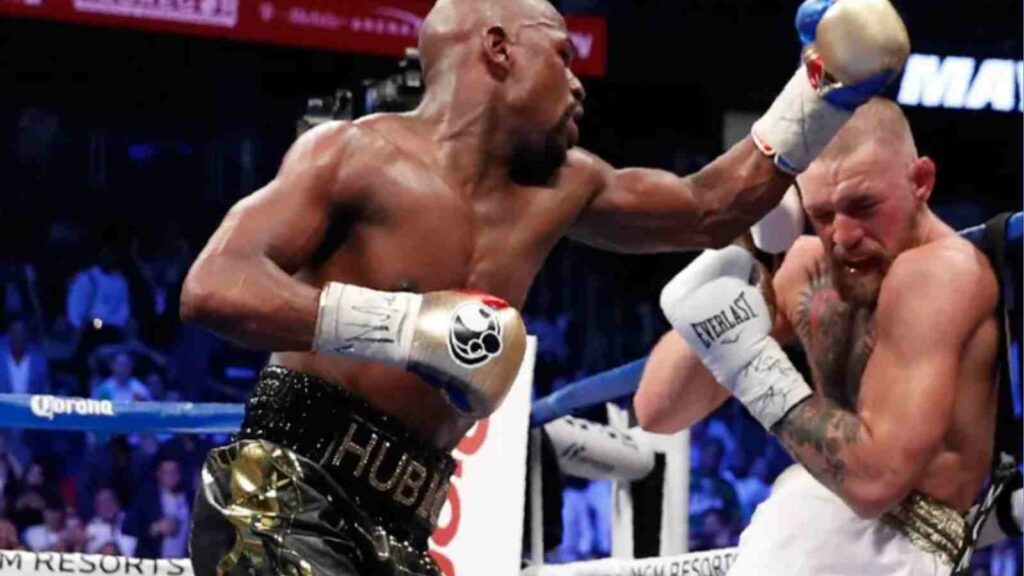 Conor McGregor (R) en route to a loss against Floyd Mayweather