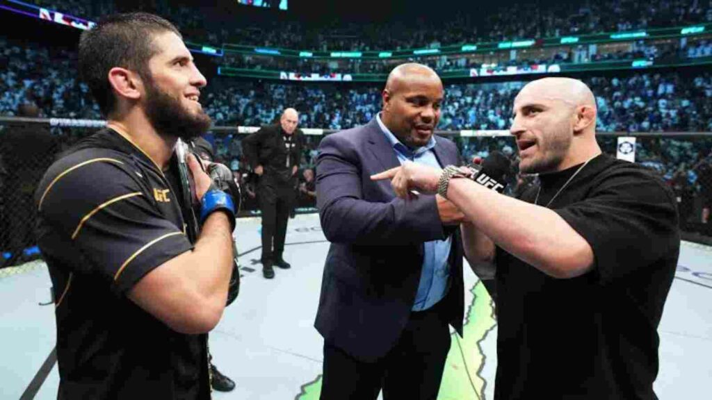 Alexander Volkanovski (R), Daniel Cormier (center), Islam Makhachev (L)