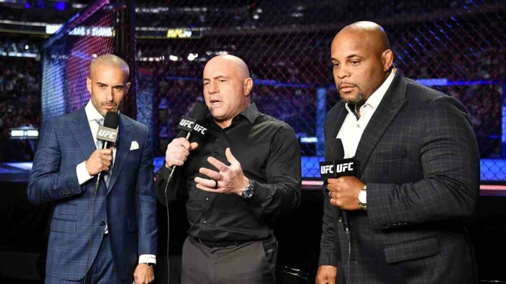 The commentary team of Joe Rogan (Centre), Jon Anik (Left) and Daniel Cormier (Right) at UFC 281