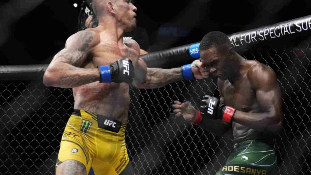 Alex Pereira (L) lands a flurry of punches, which subsequently ended the fight in the fifth round against Israel Adesanya (R) at UFC 281