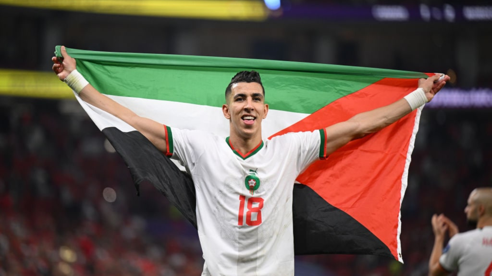 Moroccon player waves the Palestinian flag after securing Quarterfinal entry defeating Canada in the 2022 FIFA World Cup