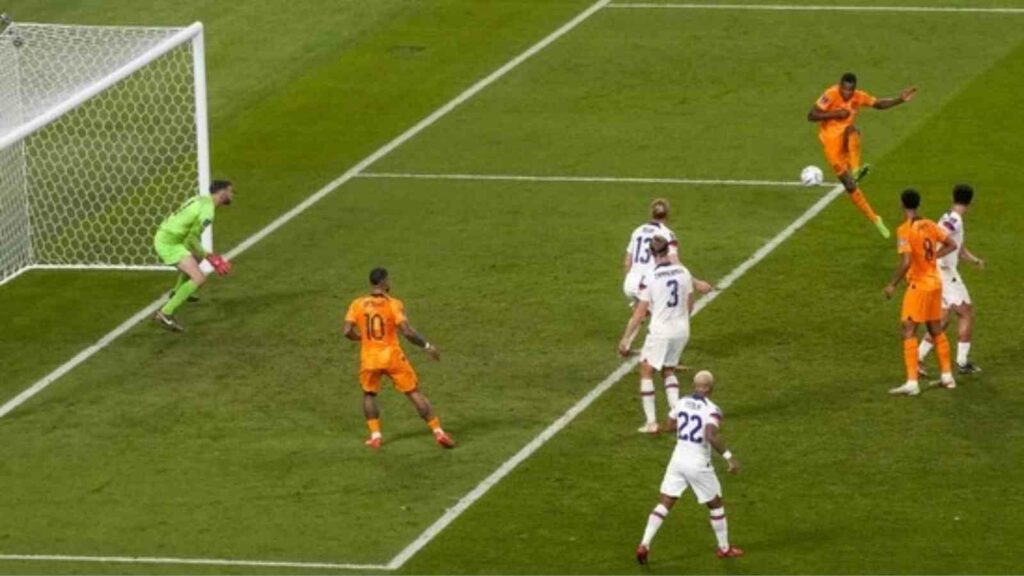 Denzel Dumfries scores a goal while Memphis Depay watches for the Netherlands